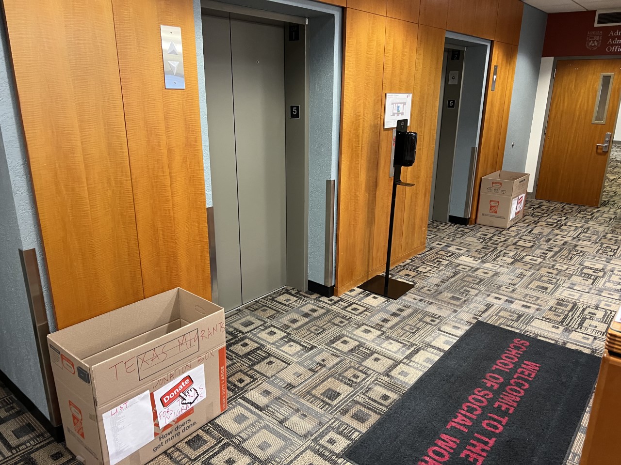 Two donation boxes outside the elevators on the 5th floor of Maguire Hall.